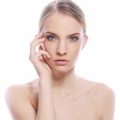 Portrait of beautiful woman with clean face over white background